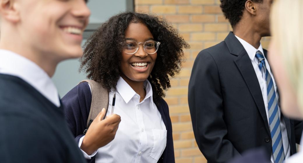 Three teenage students wearing school uniforms.